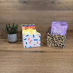 Sachet Box Leopard — mehrere Farben nebeneinander, gefüllt mit Portionsbeuteln